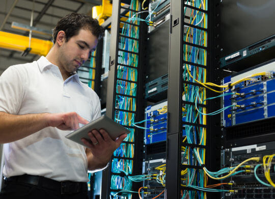 IT technician with network equipment and cables